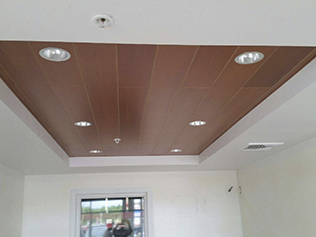 wooden panel ceiling with recessed lighting